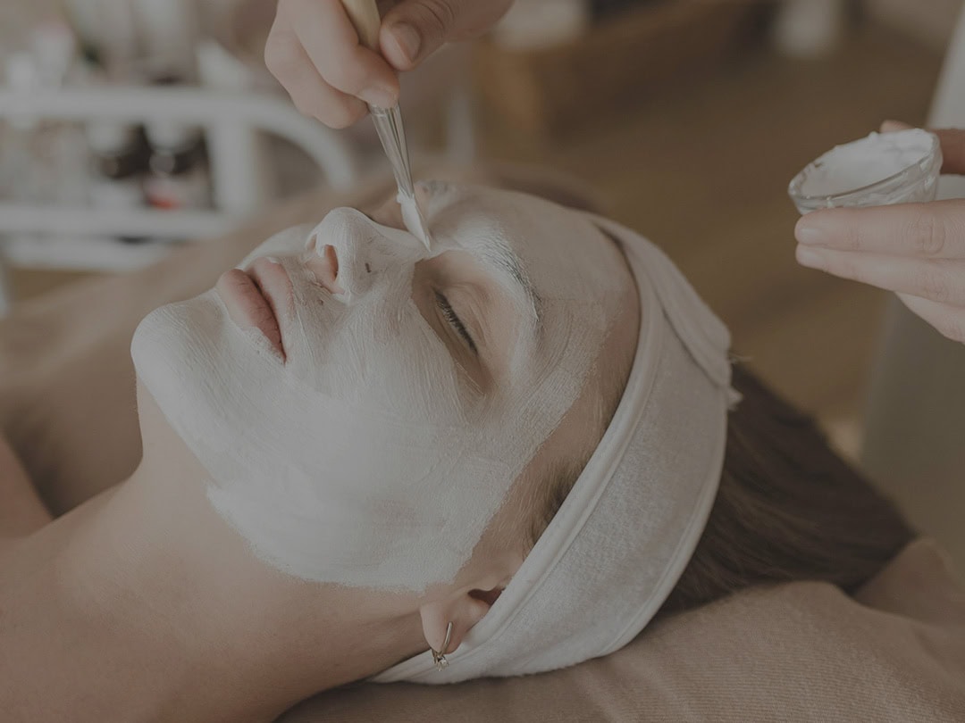 Relaxing facial treatment in a luxury beauty salon setting.